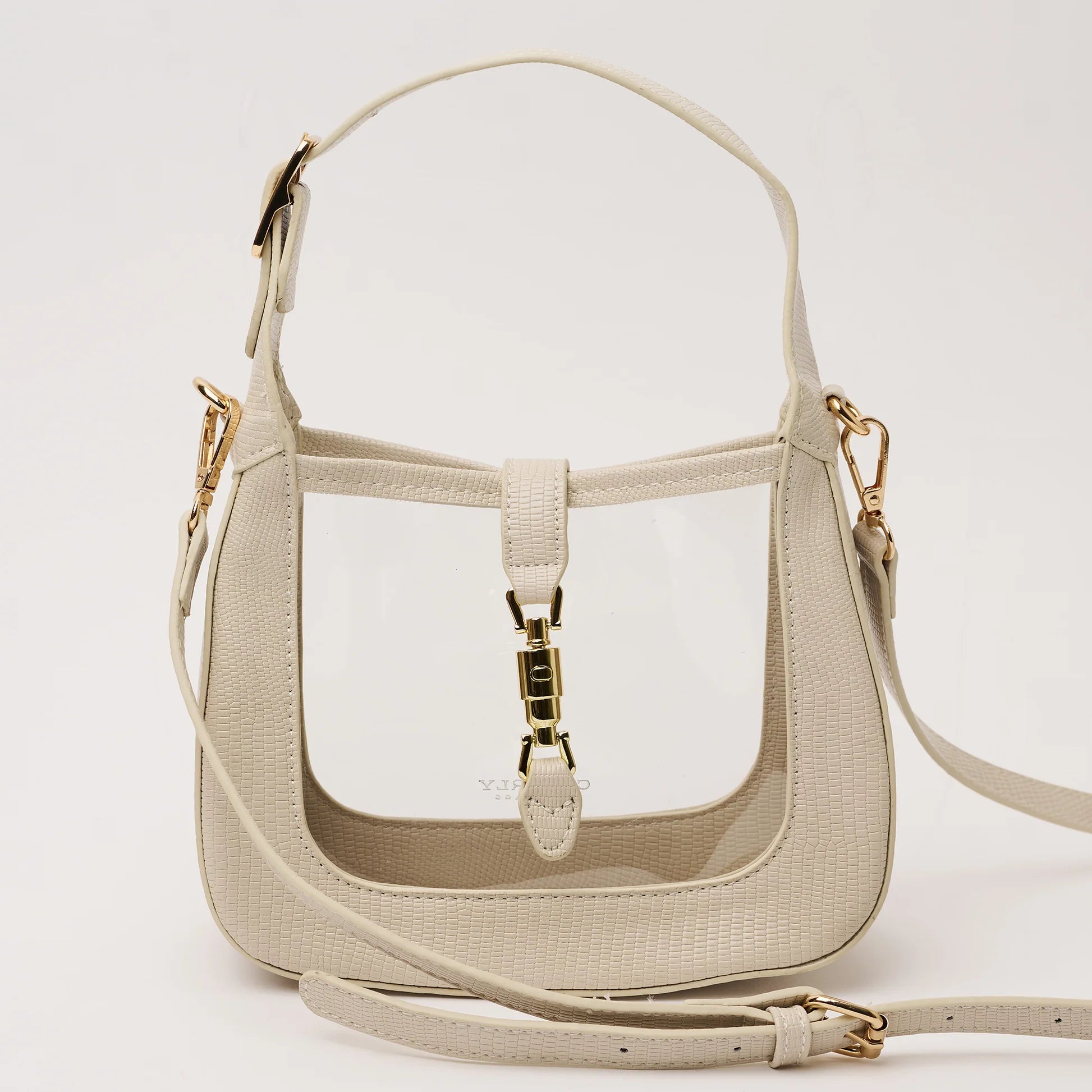 clear handbag with ivory trim and short strap and and longer cross body strap and gold hardware