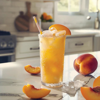 peach iced beverage on a counter with peach slices around