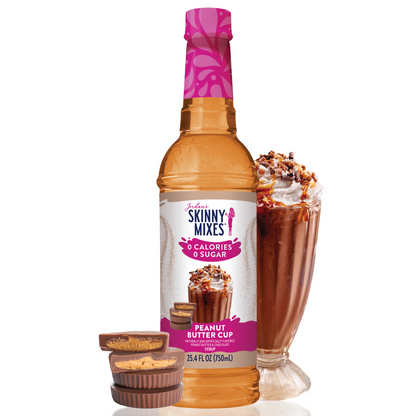 bottle of Peanut Butter Cup Sugar Free Syrup arranged with candies and a beverage