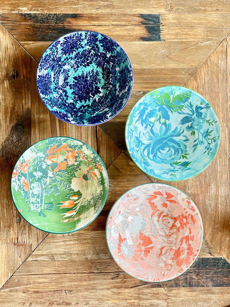top view of 4 assorted colorful bowls arranged on a table.
