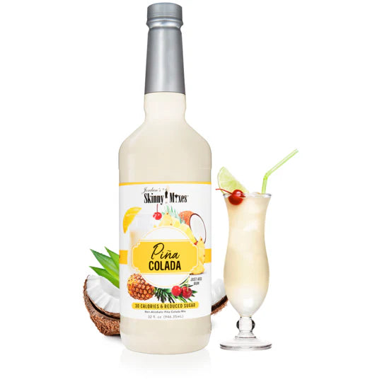 bottle of pina colada skinny syrup set next to a glass of pina colada and a coconut.