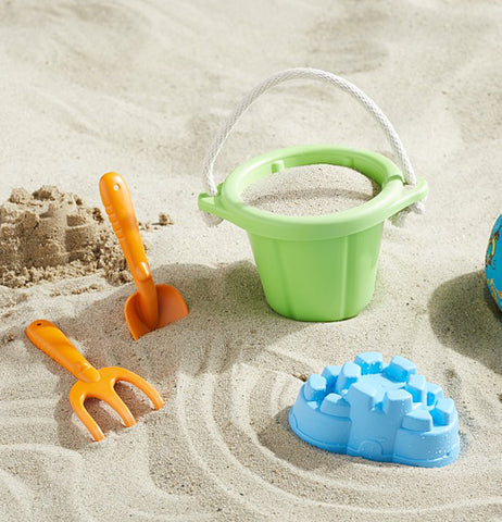 bucket, and sand tools arranged in the sand.