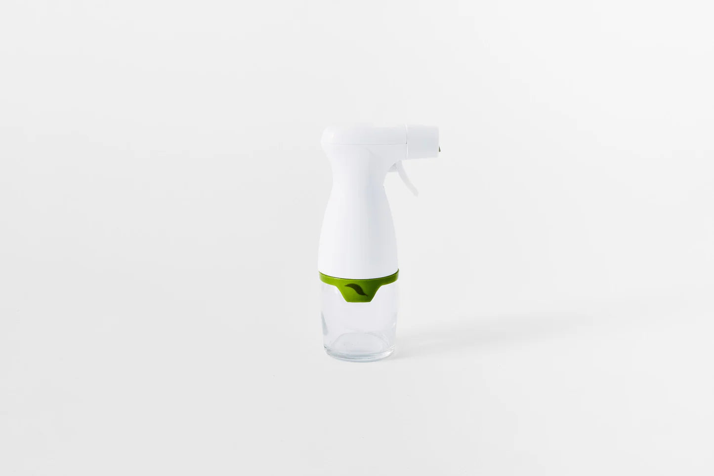 White spray bottle with glass base on a white background
