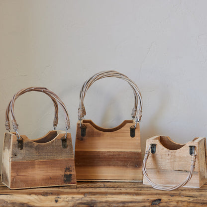 3 sizes of wooden handbag shaped boxes with handles.