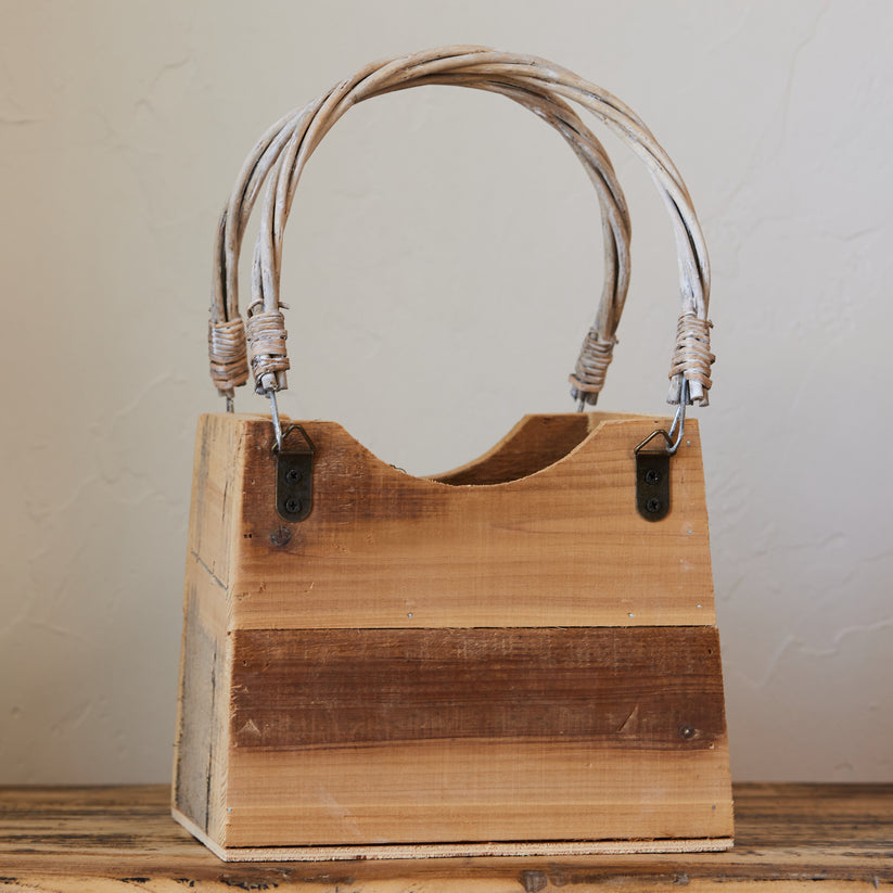 wooden hand bag shaped basket with handles.