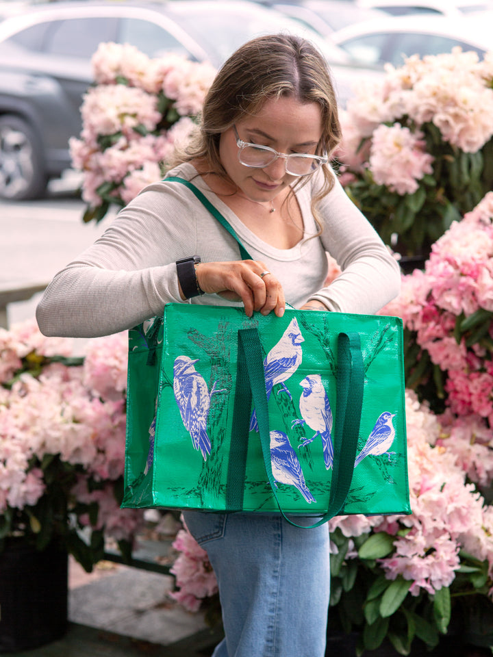 person carrying Songbird Shoulder Tote and looking inside