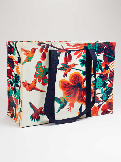 navy handled tan tote with teal ,red, orange, and navy flowers and hummingbird pattern