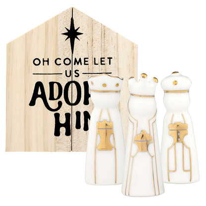 3 ceramic wise men set in front of a wooden box shaped like a creche and printed in black with o come let us adore him