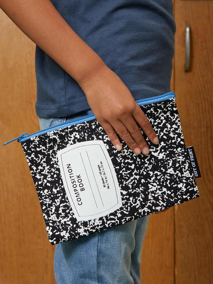 a person holding the Composition Notebook Pouch in front of a door