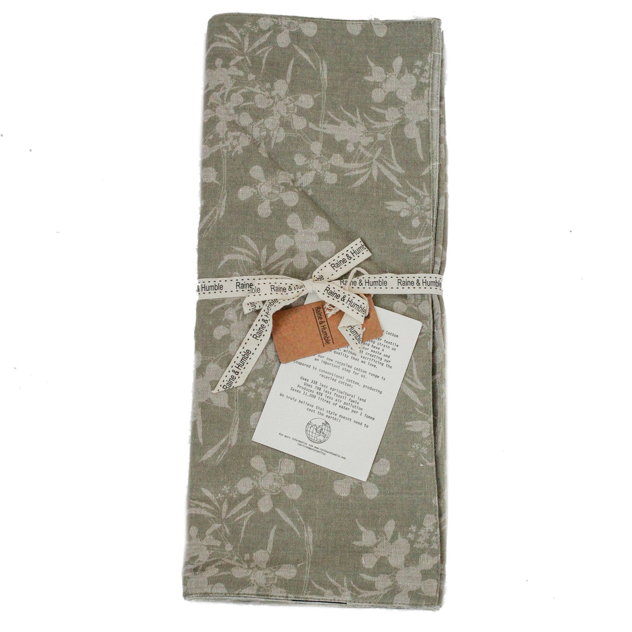 sage green runner with botanical design folded and tied with a ribbon.