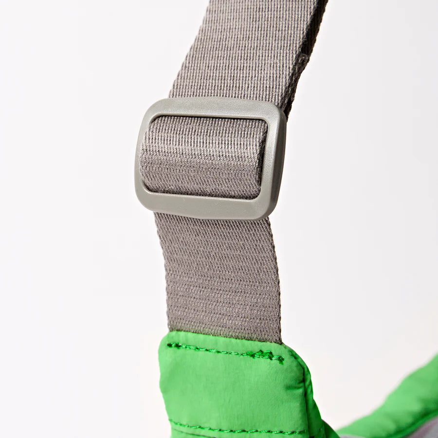 close-up of grey strap on green shoulder bag