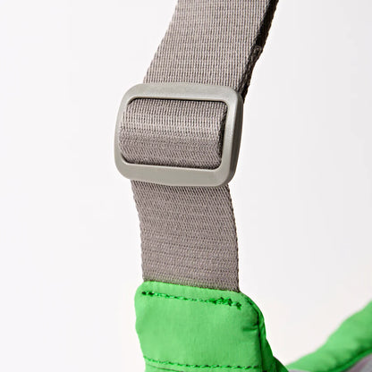 close-up of grey strap on green shoulder bag