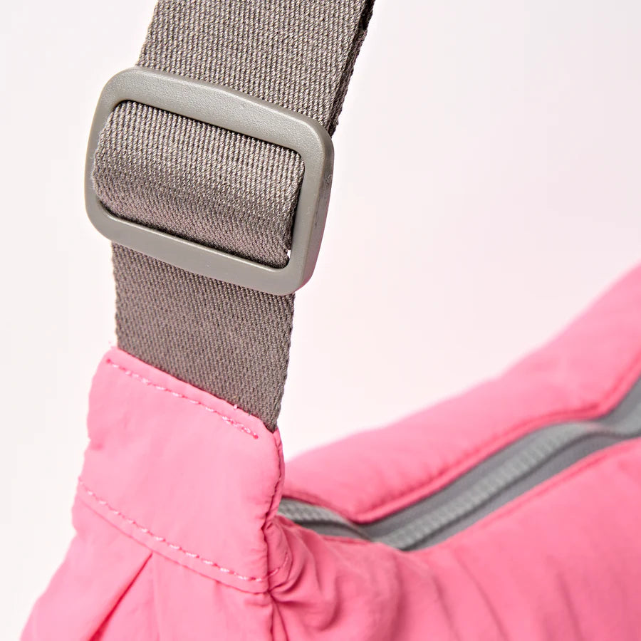 close-up of light grey strap on pink shoulder bag