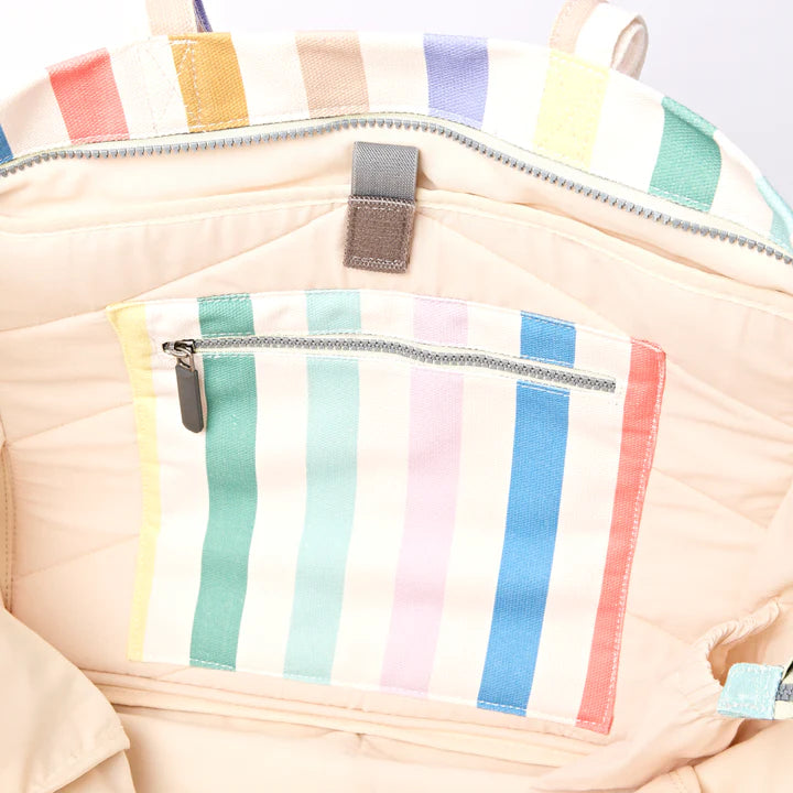 interior view of Multicolored striped tote showing zippered pocket and laptop sleeve