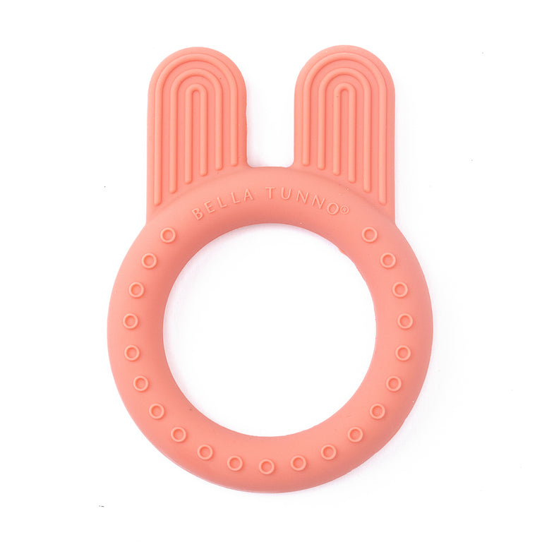 round pink teething ring with bunny ears on a white background.
