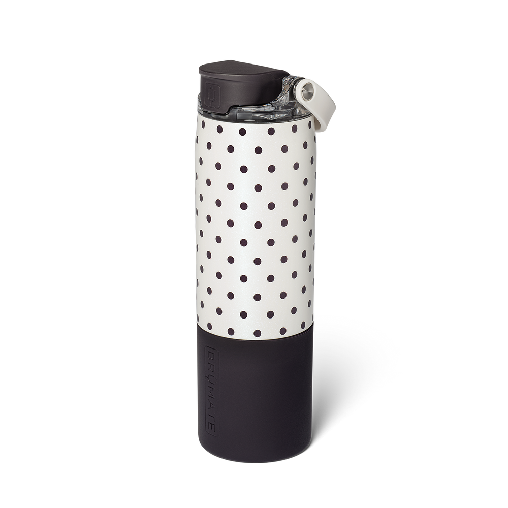 A reusable insulated tumbler with a black and white polka dot pattern and a black flip lid, shown on a clean white background.