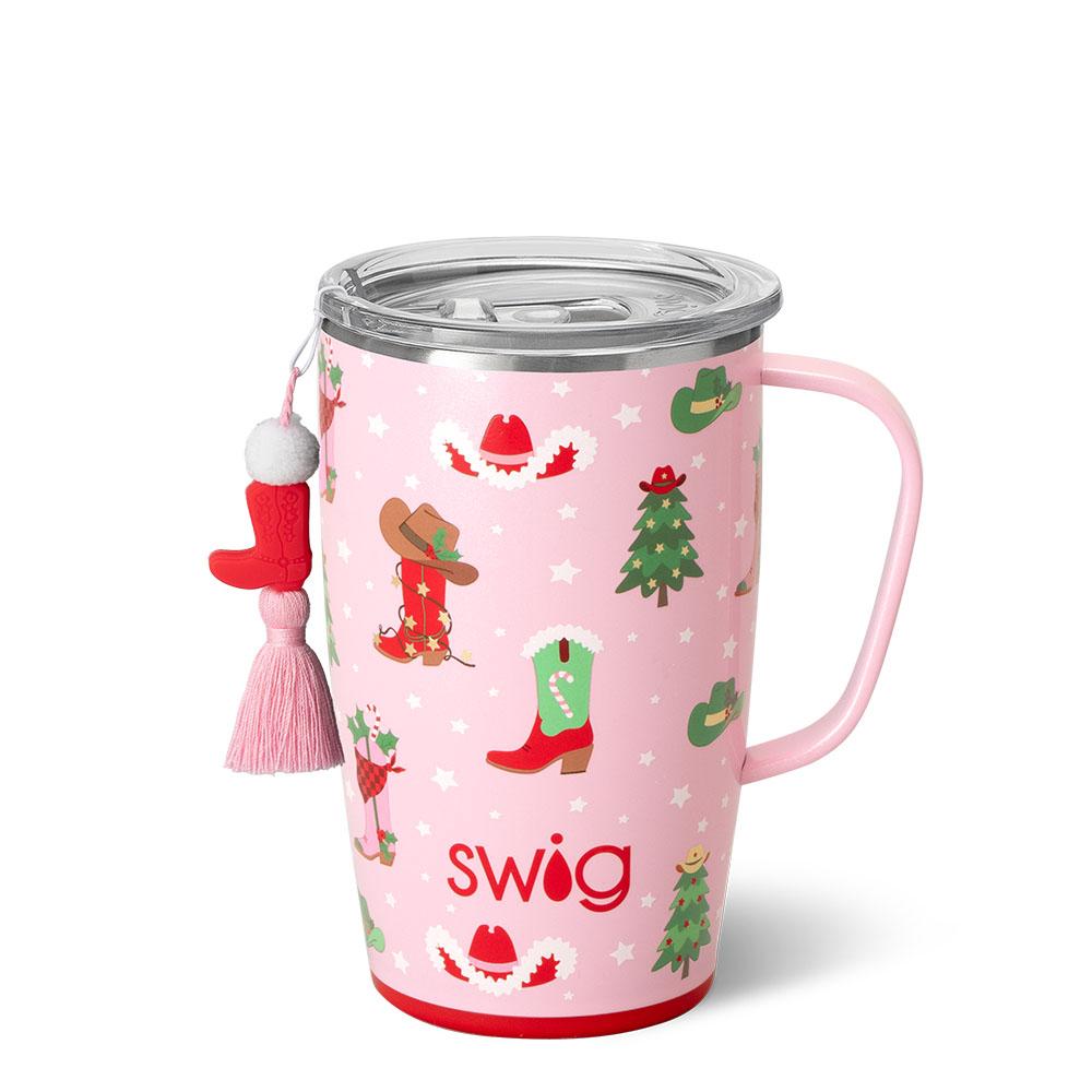 pink travel mug with christmas themed cowgirl boots and hats and christmas tree.