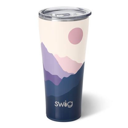 32 ounce moon shine travel tumbler with a mountain range in hues of pink and purple displayed against a white background