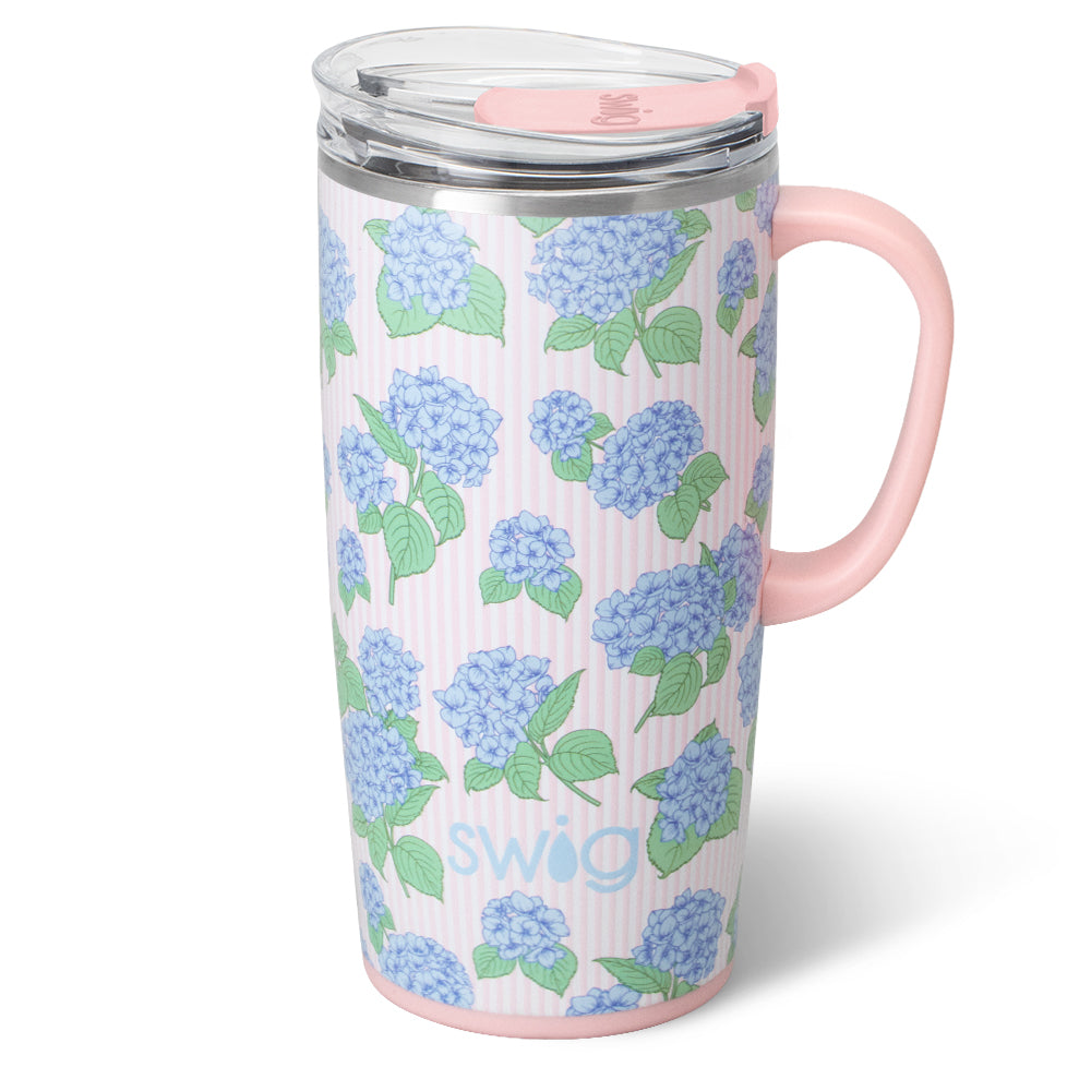 Travel mug with blue floral pattern and pink handle on a white background
