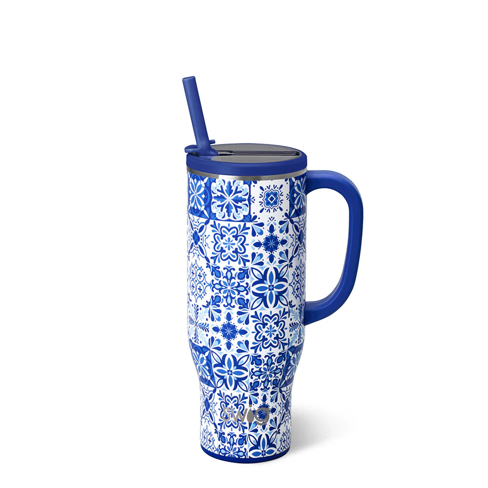 Blue and white patterned tumbler with blue handle and straw on a white background