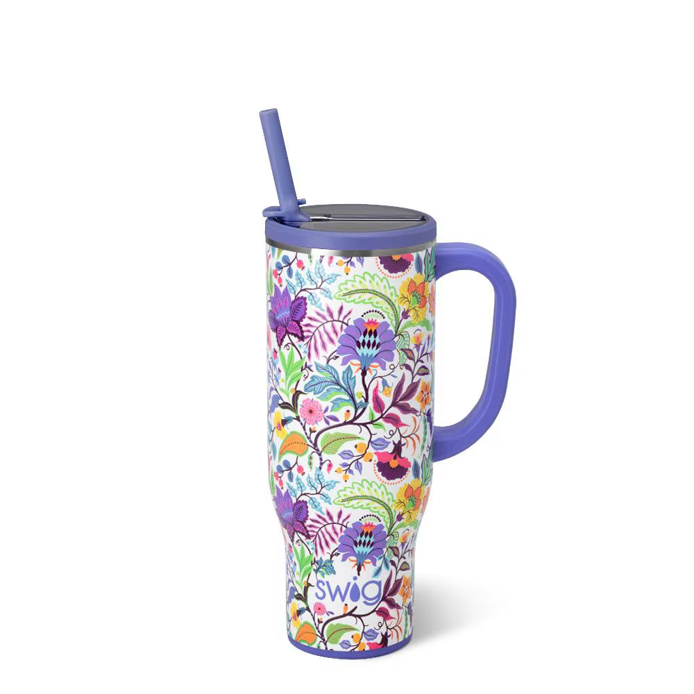 white tumbler with blue straw and handle and all-over colorful floral design