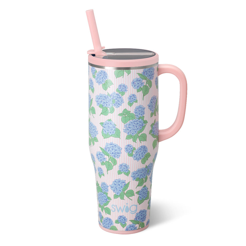 blue Floral-patterned mug with pink handle and straw on a white background