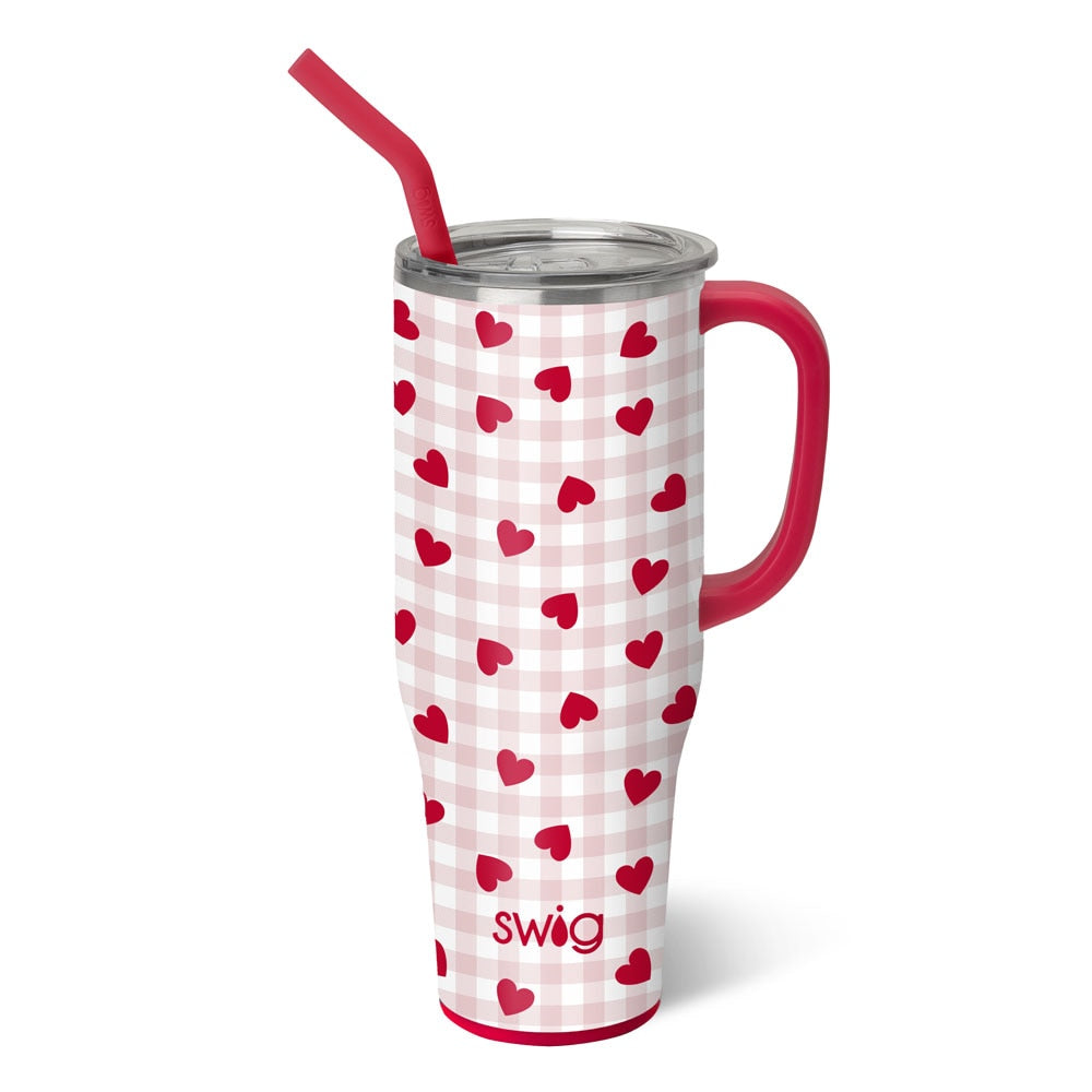 pink and white check tumbler with heart hearts on it and a red handle and straw.