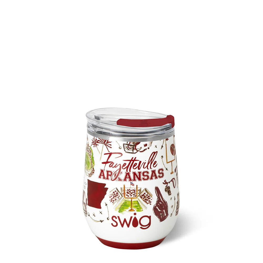 A white insulated stemless wine tumbler with a clear lid and red lip, decorated with 'Fayetteville Arkansas' text and football themed illustrations in red, green, and brown. 