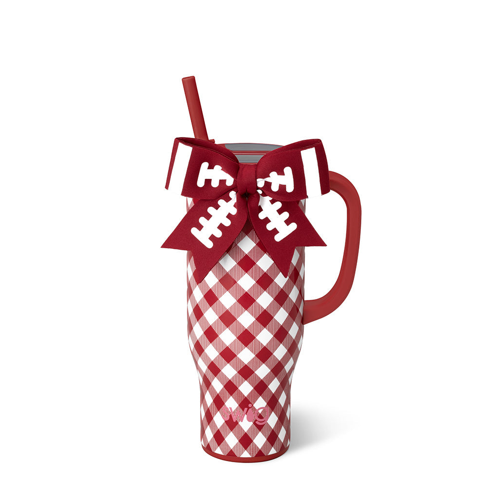 A red and white gingham insulated travel tumbler with a red handle, a red straw, and on the rim a decorative red bow with white football line details. 