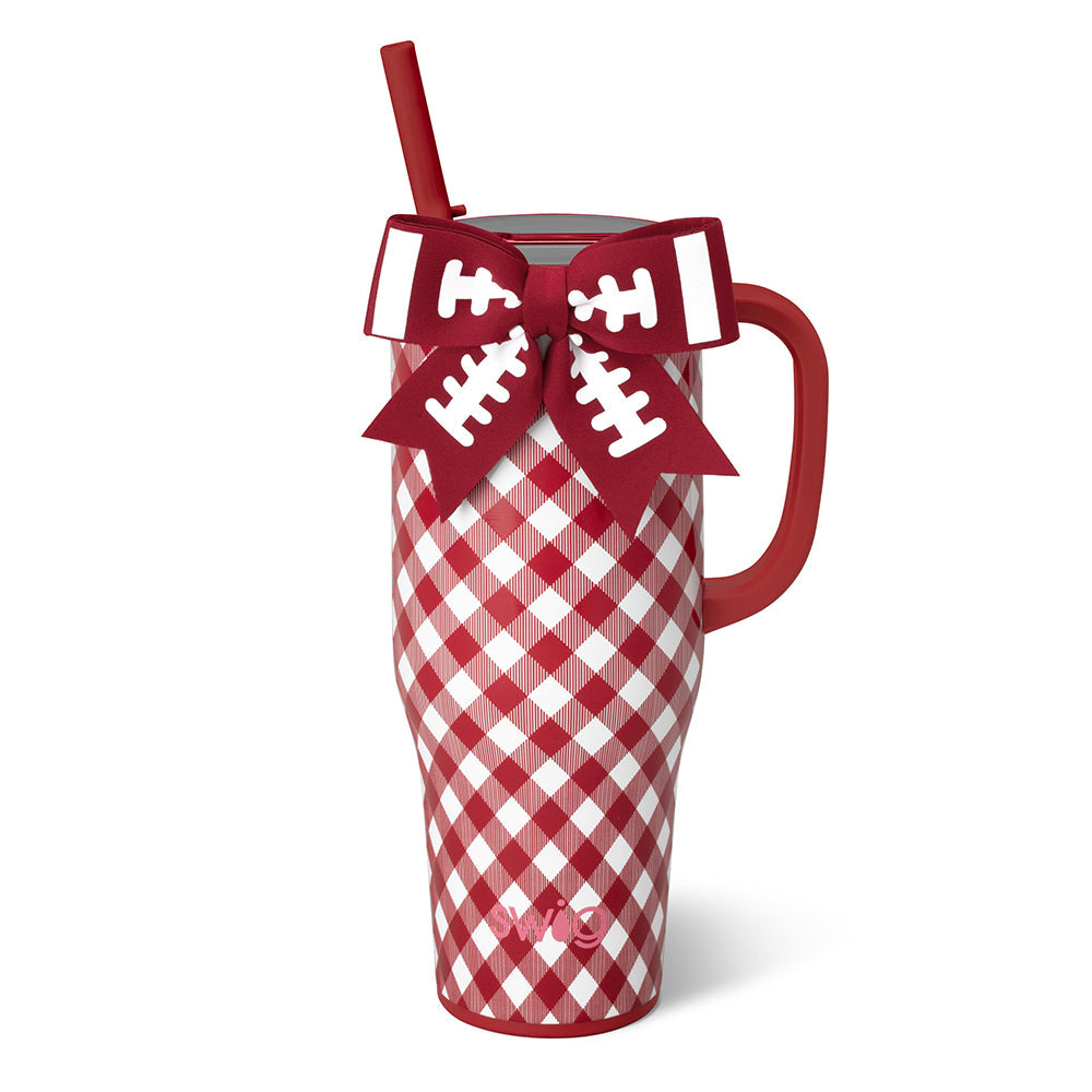 A red and white gingham insulated travel tumbler with a red handle, a red straw, and on the rim a decorative red bow with white football line details. 