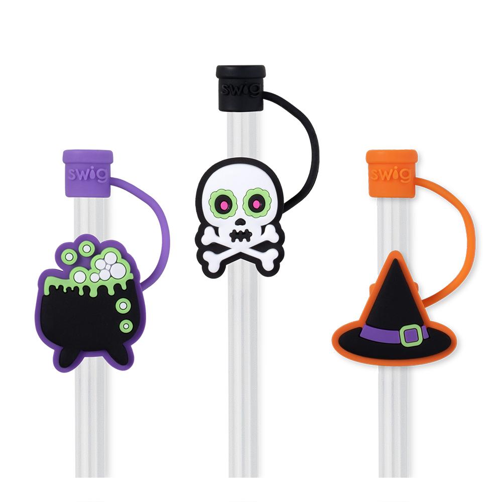 3 straw toppers on straws, toppers include a boiling caldron, a skull, and a which's hat.