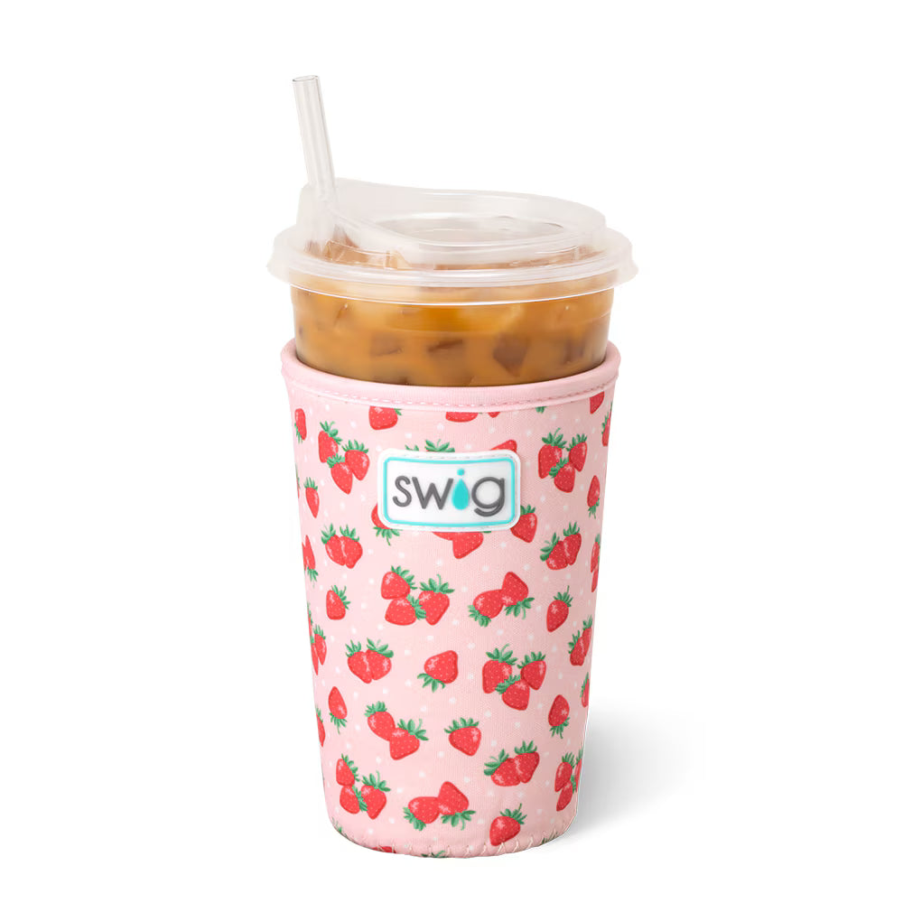 Iced beverage with a pink beverage sleeve on it that is covered in a red strawberry design