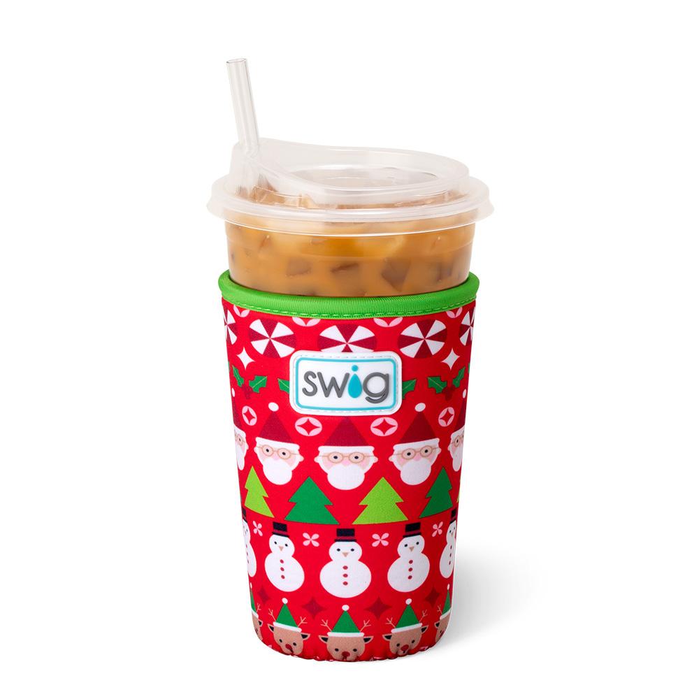 red coolie with santa, snowmen and other christmas icons printed on it on an iced beverage.