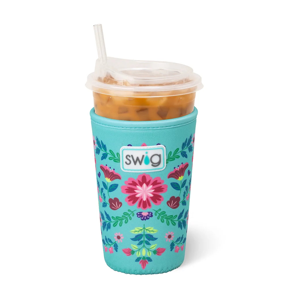 Teal floral-patterned cup cooler with an iced coffee inside on a white background