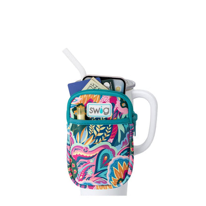 colorful floral patterned pouch on a white tumbler unzipped showing cash and cards in it and chap stick in the front pocket.