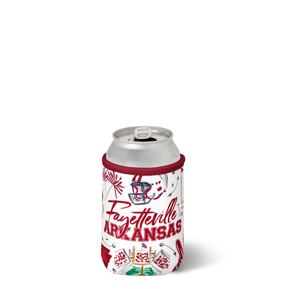 A silver aluminum can inside a white can cooler sleeve featuring football themed graphics and the text 'Fayetteville ARKANSAS' on a clean white background.