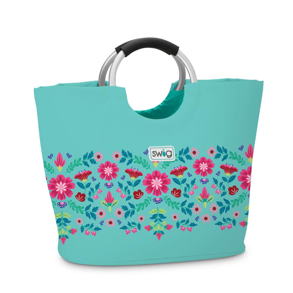 Teal tote bag with floral pattern and ring handles on a white background