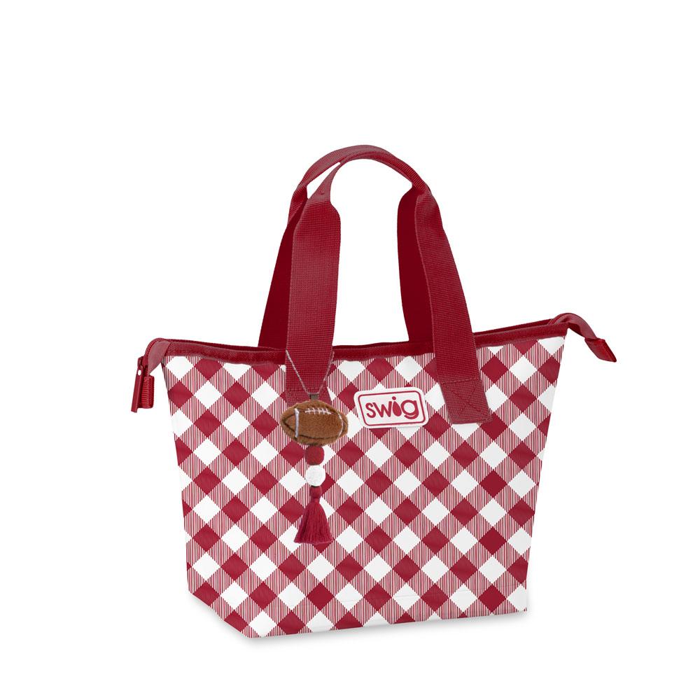 A red and white checkered lunch tote bag with red handles, featuring a Swig logo patch and a football charm.