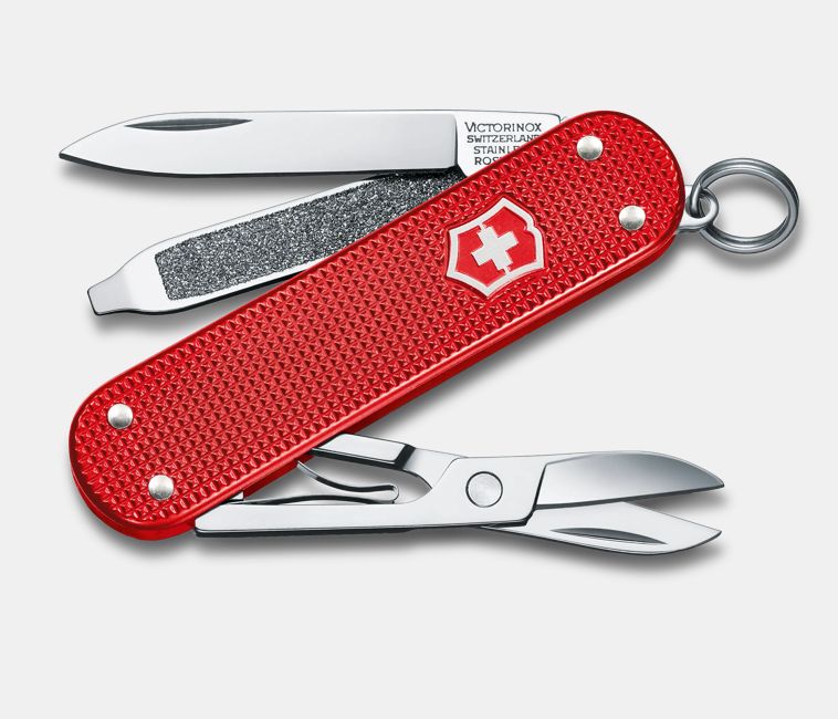 textured red Swiss army knife with several tools partially opened