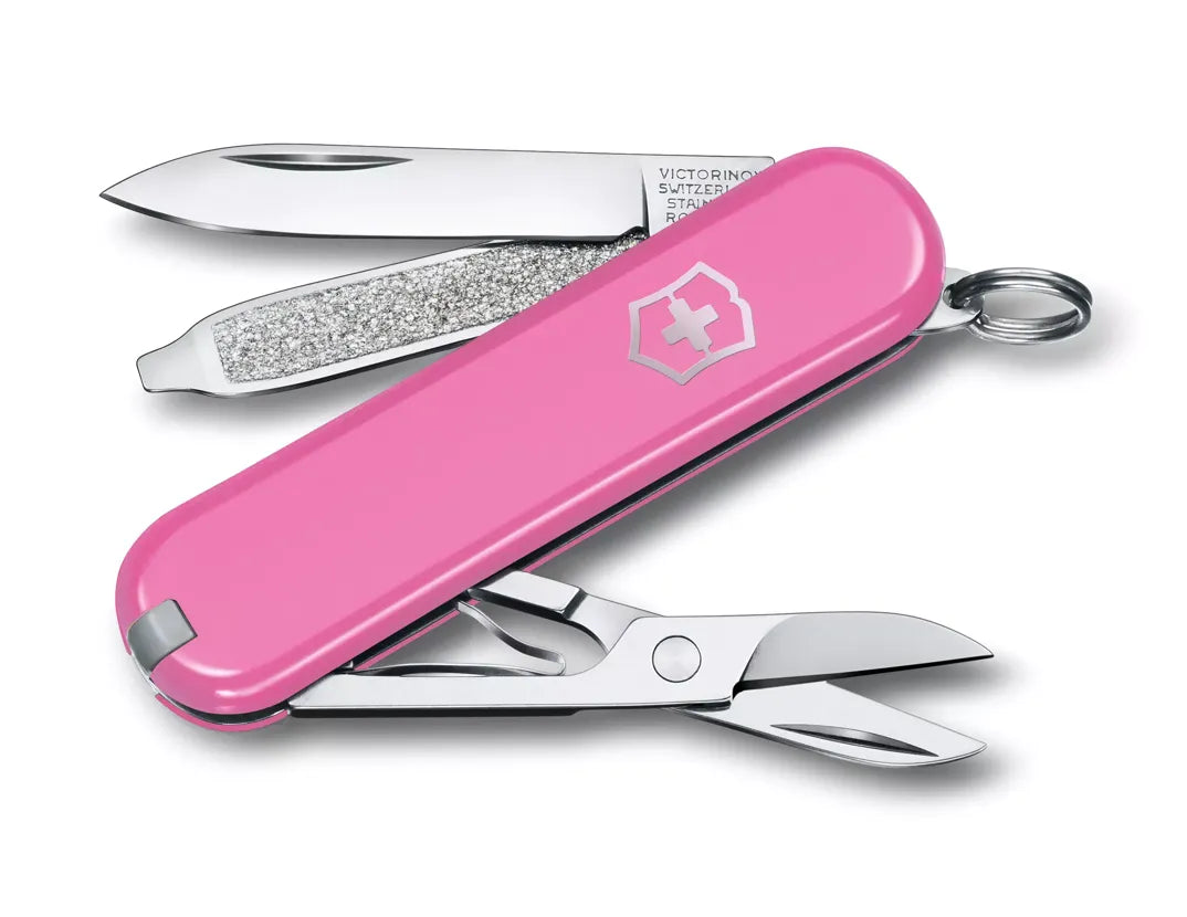 pink Swiss army knife with several tools partially opened