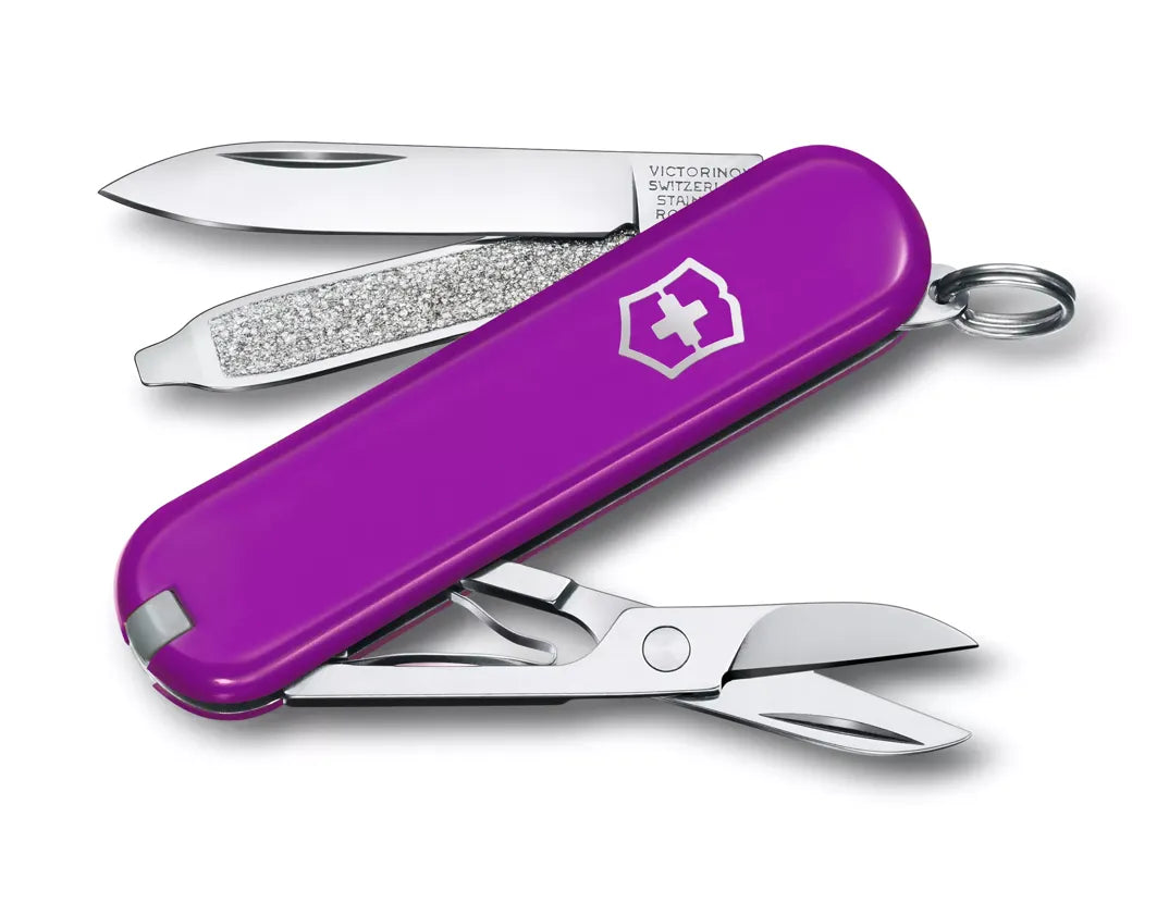 purple Swiss army knife with several tools partially opened
