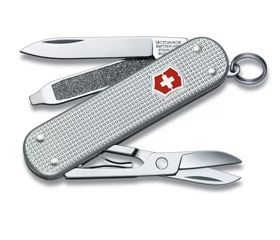 silver Swiss army knife with several tools partially opened