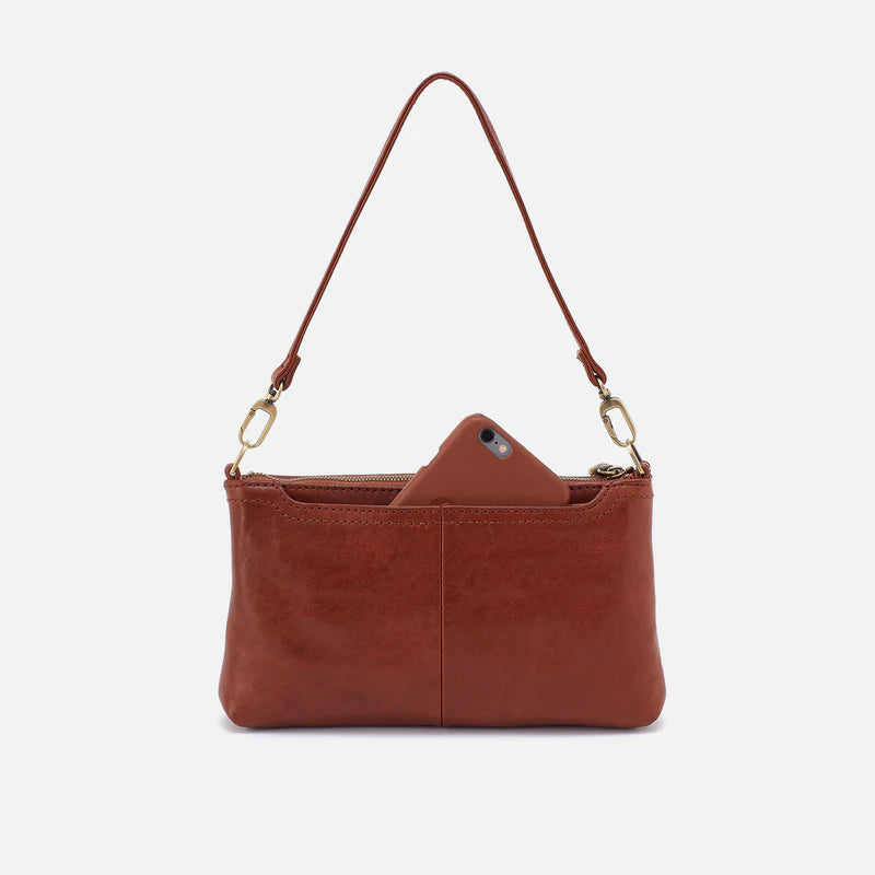 back view showing a phone in the phone pocket of the darcy crossbody in the color pecan ridge