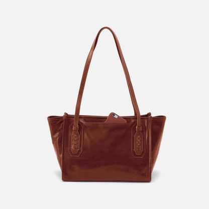 back view of the  expedition small tote bag in the color pecan ridge showing a phone in the phone pocket