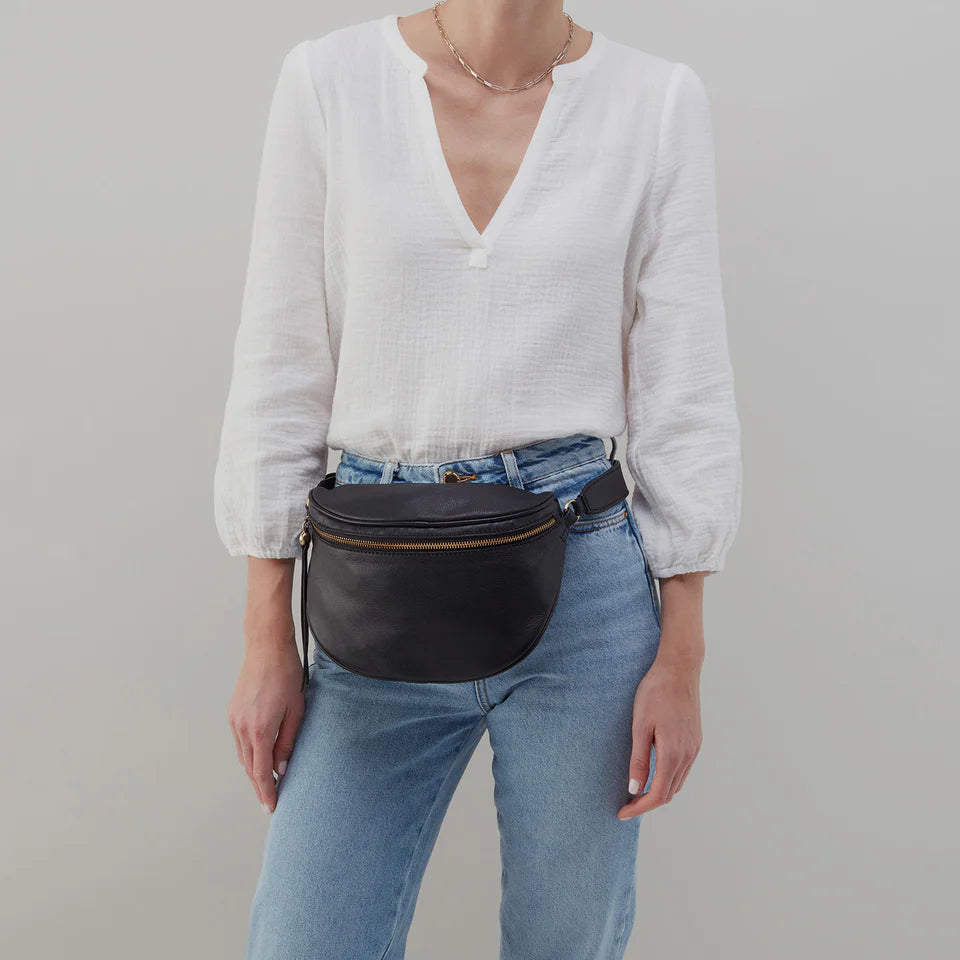 person wearing jeans and a white top with black Juno Belt Bag around their waist