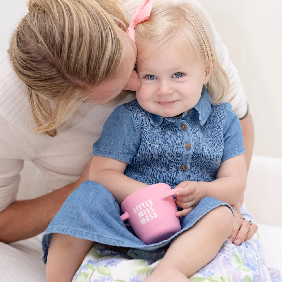 child sitting on grown-ups lap eat snacks from little miss mess happy snacker.