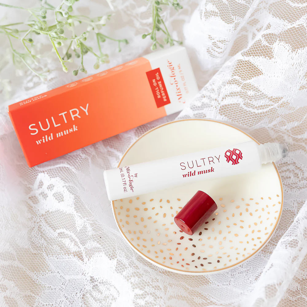 Sultry wild musk packaging and product on a decorative plate with a lace background