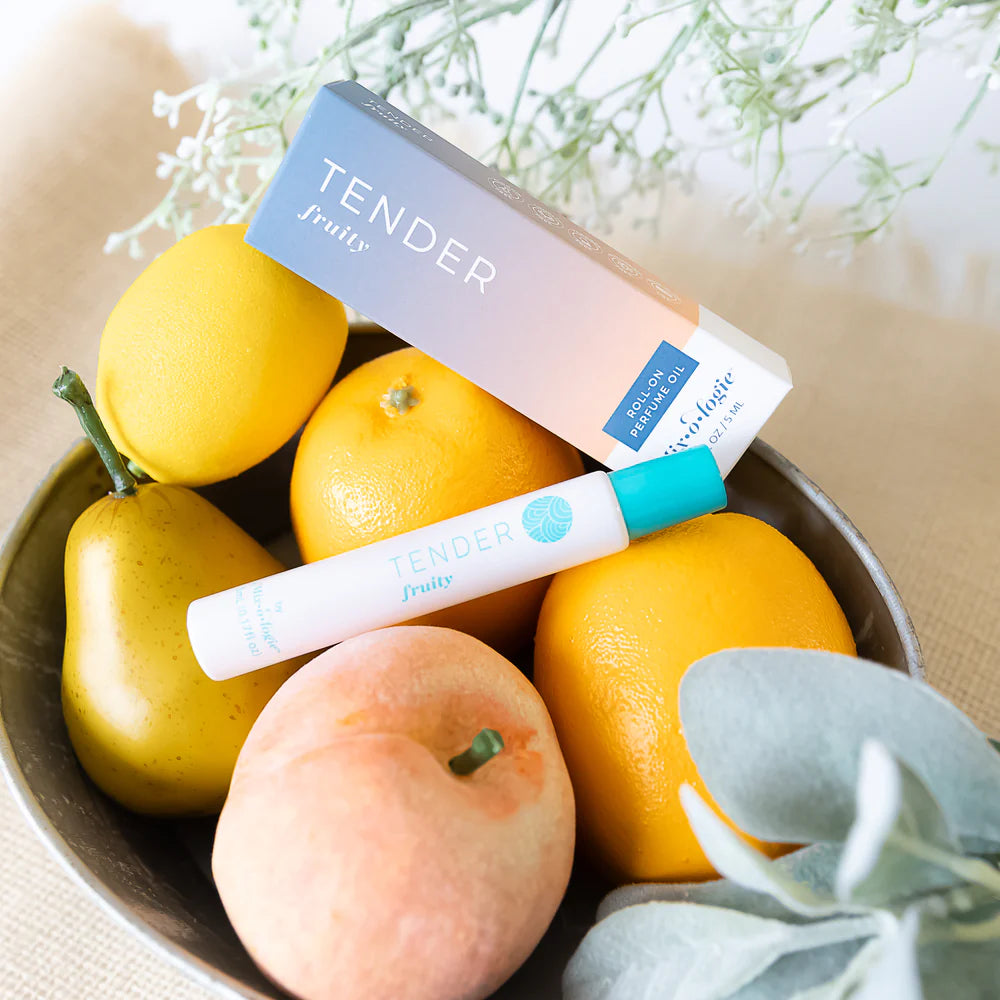 Tender perfume product with lemons, pears, and an apricot in a bowl.