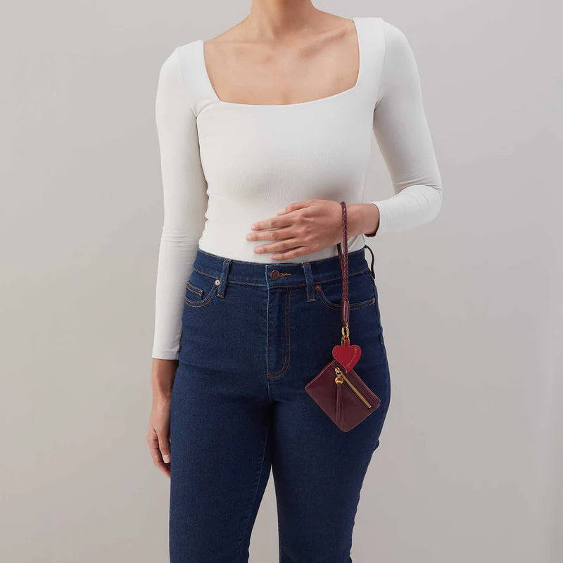 person wearing jeans and white top holding mulberry glaze Lasso Phone Wristlet on their wrist