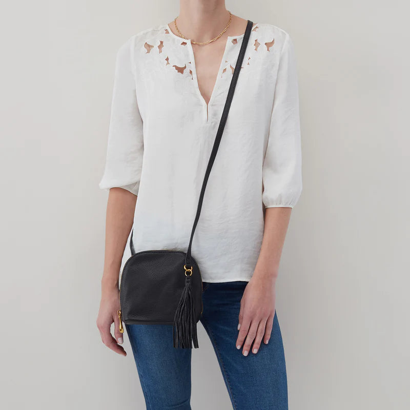 person wearing jeans and white top with black Nash Crossbody over their shoulder.